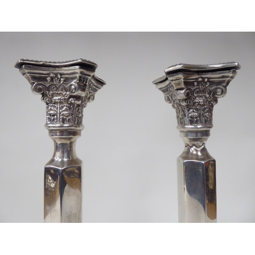 88 - A pair of Victorian silver candlesticks with bead bordered Corinthian capitals and straight, hexagon... 