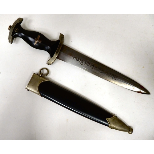 89 - A German SS dagger, the black stained wooden handgrip with emblems, the hilt numbered 6427, the 8.5