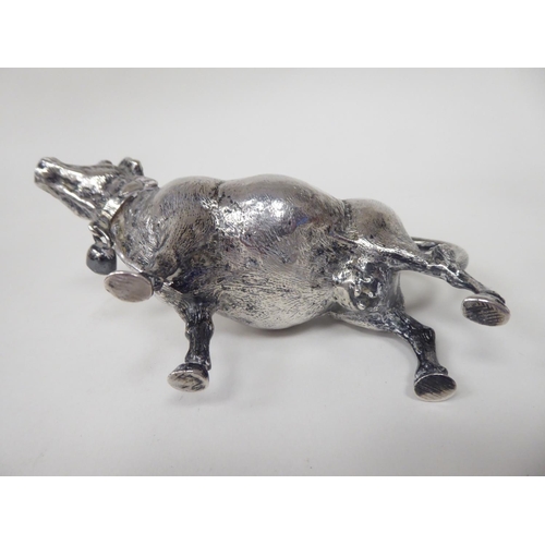 93 - A 19thC Continental silver coloured metal cow creamer, the hinged cap incorporating a bee finial, th... 