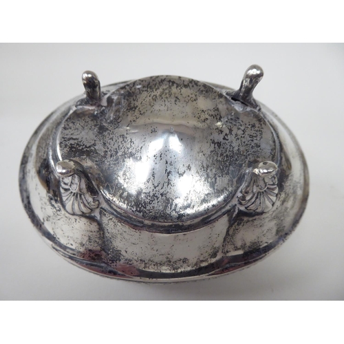 94 - A late 19thC Continental silver coloured metal jewellery box of oval bowl form with an outset, hinge... 