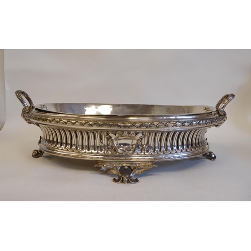 98 - An early 20thC silver plated, two-part serving dish of oval form, profusely cast with maskheads, pie... 