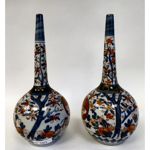 101 - A pair of 20thC Japanese Imari porcelain bottle vases with narrow necks, traditionally decorated in ... 