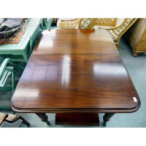 11 - A late Victorian mahogany dining table with a thumb moulded edge and rounded corners, raised on turn... 