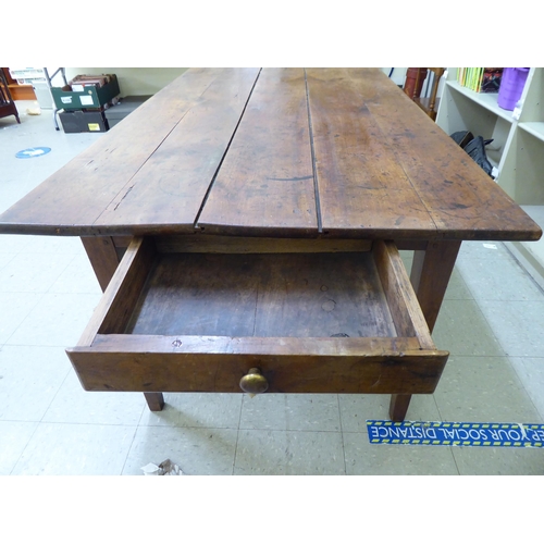 124 - A mid 19thC Continental cherrywood farmhouse table with a planked single end draw leaf, raised on sq... 