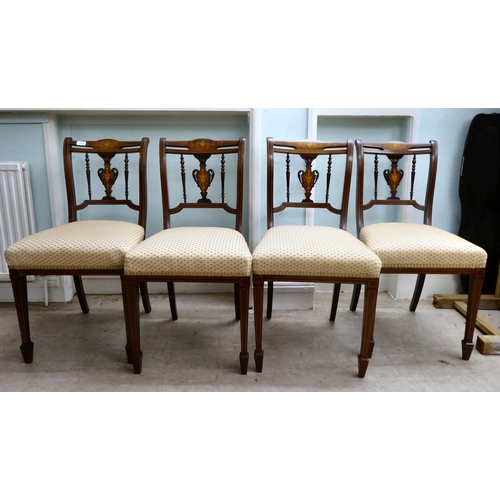 13 - A set of four Edwardian string inlaid, marquetry mahogany dining chairs with later fabric upholstere... 