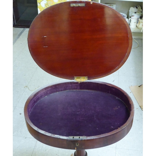 130 - A Regency mahogany work table with a hinged top, raised on a tripod base  29