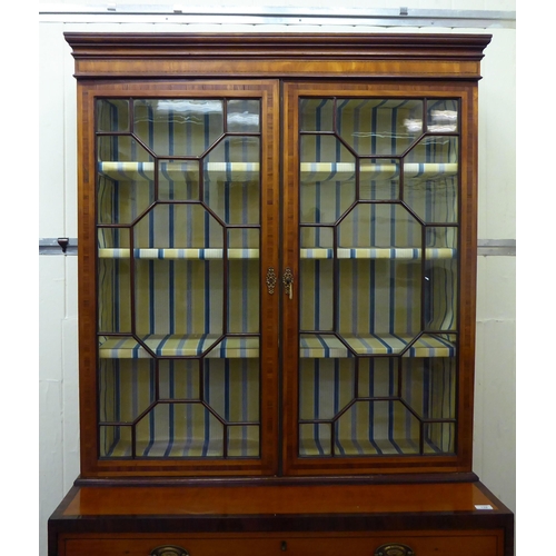 139 - A Regency rosewood crossbanded satinwood cabinet on chest with two astragal glazed doors, over five ... 