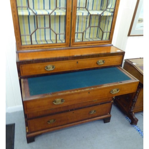 139 - A Regency rosewood crossbanded satinwood cabinet on chest with two astragal glazed doors, over five ... 