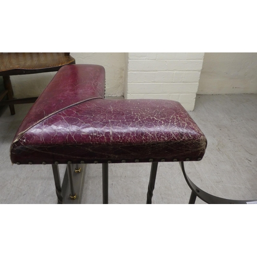 149 - A stainless steel and brass club fender with a pair of L-shape, studded, maroon hide seat corners, o... 