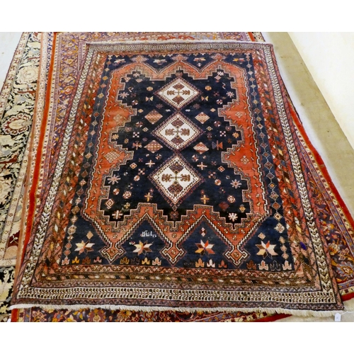 16 - A Sirjan (Iran) rug, decorated with three central diamond shaped motifs, bordered by repeating desig... 