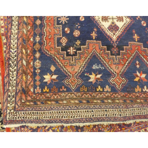 16 - A Sirjan (Iran) rug, decorated with three central diamond shaped motifs, bordered by repeating desig... 