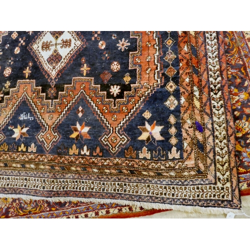 16 - A Sirjan (Iran) rug, decorated with three central diamond shaped motifs, bordered by repeating desig... 