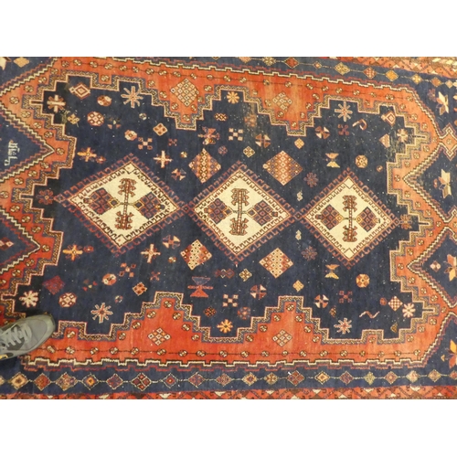 16 - A Sirjan (Iran) rug, decorated with three central diamond shaped motifs, bordered by repeating desig... 