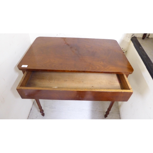 169 - A 19thC figured mahogany veneered side table with a deep apron, raised on slender, turned, tapered l... 