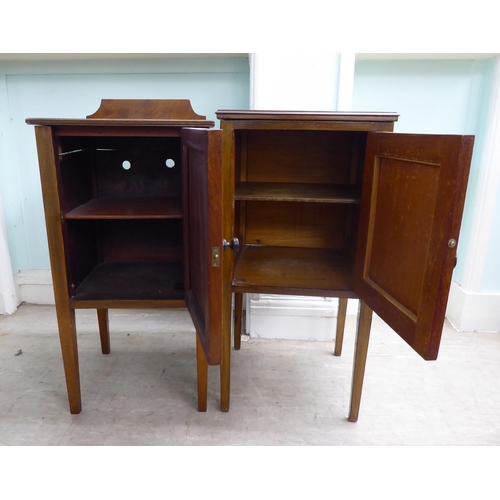 17 - Two similar Edwardian, string and ebony inlaid, mahogany bedside single door cabinets, raised on squ... 