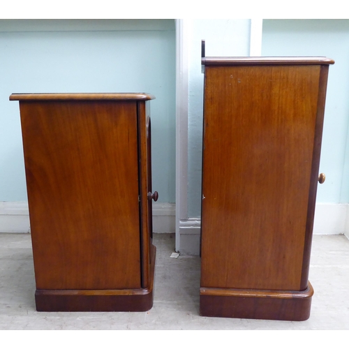 18 - Two similar late Victorian, mahogany single door bedside cupboards, on a plinth  30