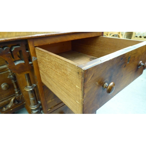 182 - A late Victorian walnut Davenport with a sloping hinged lid, set with a red hide scriber, over a pan... 