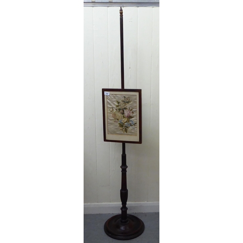 188 - A late Victorian mahogany polescreen with a floral tapestry, height adjustable panel, raised on a ci... 