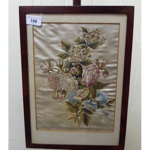 188 - A late Victorian mahogany polescreen with a floral tapestry, height adjustable panel, raised on a ci... 