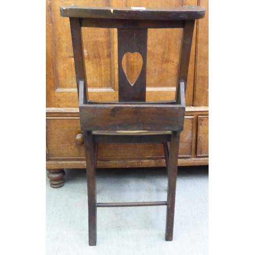 191 - A modern mahogany finished chapel chair with a painted seat, fashioned as a Teddy bear