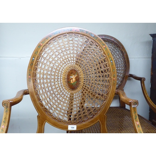 194 - A pair of Edwardian style string inlaid and floral painted, mahogany framed chairs with floral paint... 