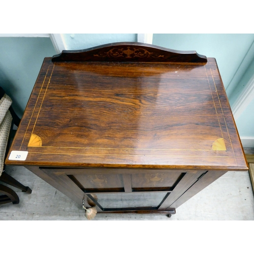 20 - An Edwardian string inlaid rosewood music cabinet with a panelled and glazed door, on a bracket plin... 