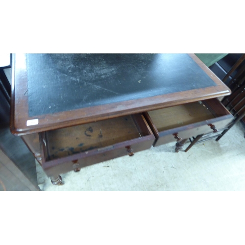 201 - A mid 19thC mahogany writing table, the rexine scriber over a pair of inline drawers with bun handle... 