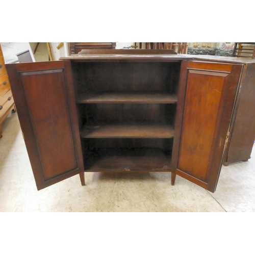 206 - An Edwardian mahogany side cabinet, the shelved interior enclosed by a pair of inlaid, oval panelled... 