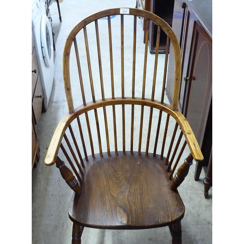 211 - A mid 19thC country made, yew, beech and elm framed, high hoop and spindle back arm chair, the solid... 