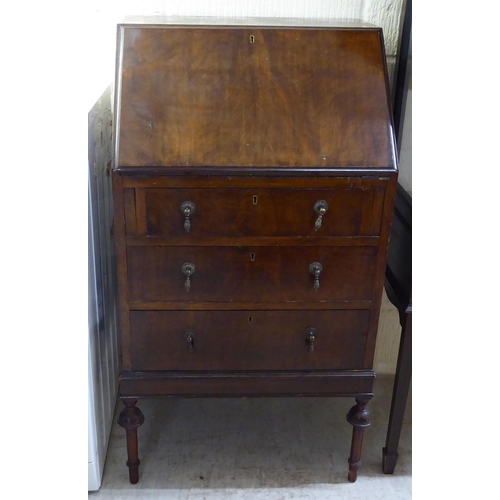 212 - A lady's 1930s mahogany bureau, the three long drawers with pendant handles, raised on slender, bulb... 