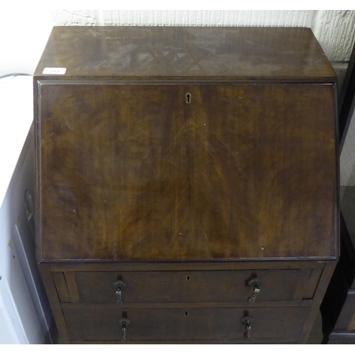 212 - A lady's 1930s mahogany bureau, the three long drawers with pendant handles, raised on slender, bulb... 