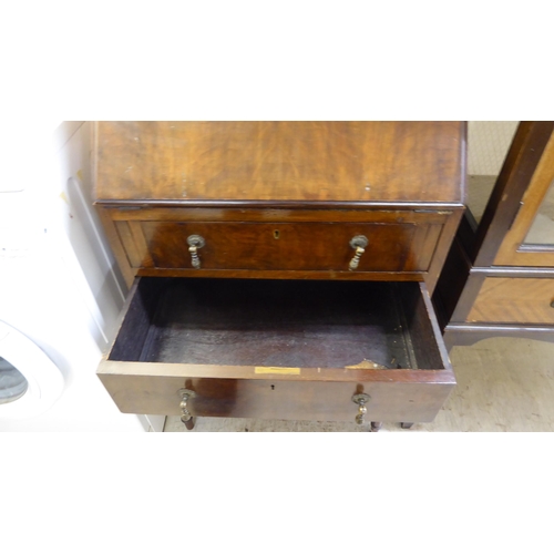 212 - A lady's 1930s mahogany bureau, the three long drawers with pendant handles, raised on slender, bulb... 