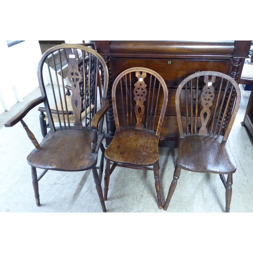 213 - Five early 20thC beech and elm framed Windsor hoop back chairs: to include a high back arm chair