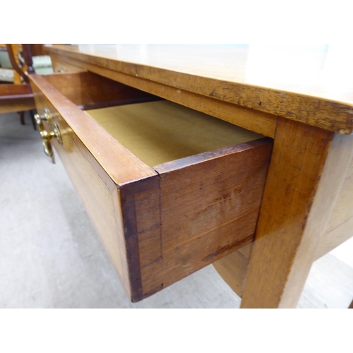 22 - A late 19th/early 20thC mahogany two drawer hall table, raised on square, tapered legs  28