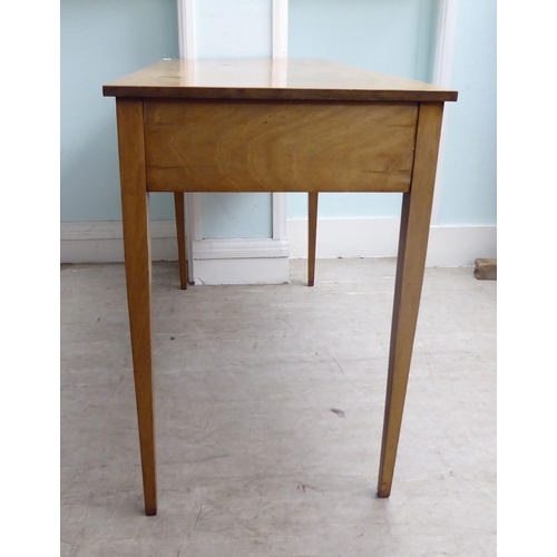 22 - A late 19th/early 20thC mahogany two drawer hall table, raised on square, tapered legs  28