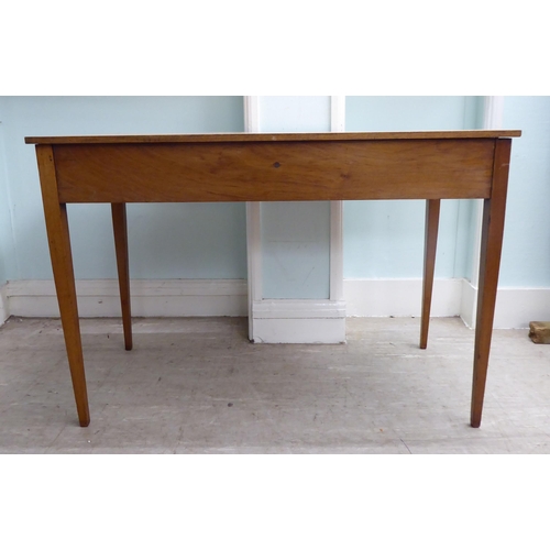 22 - A late 19th/early 20thC mahogany two drawer hall table, raised on square, tapered legs  28