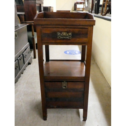 236 - An early 20thC mahogany bedside cupboard with a tray top, frieze drawer and undershelf, over a fall ... 