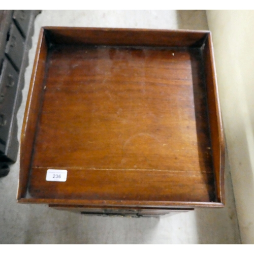 236 - An early 20thC mahogany bedside cupboard with a tray top, frieze drawer and undershelf, over a fall ... 