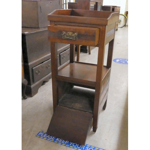 236 - An early 20thC mahogany bedside cupboard with a tray top, frieze drawer and undershelf, over a fall ... 