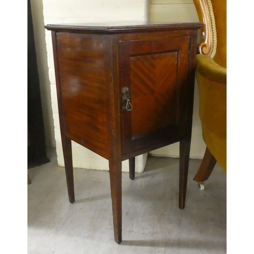 236 - An early 20thC mahogany bedside cupboard with a tray top, frieze drawer and undershelf, over a fall ... 