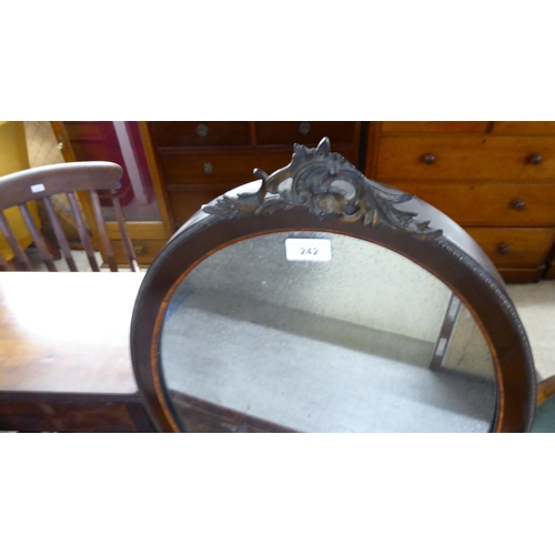 242 - A late Victorian oval mirror with an inlaid and brass finished mahogany frame, incorporating a folia... 