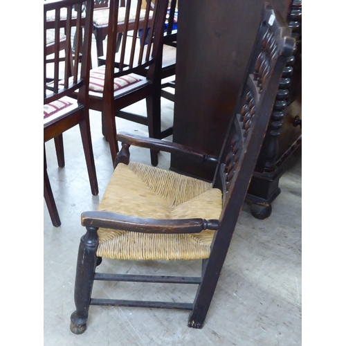 243 - A mid 19thC country made, oak framed Lancashire, high back hall chair with bobbin turned rows, over ... 