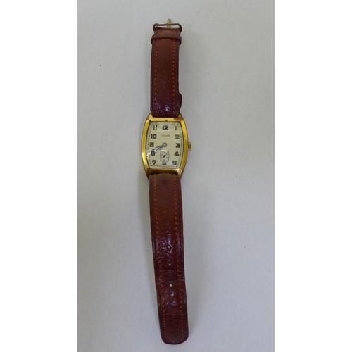 245 - A Nivada rolled gold cased, manual wind wristwatch, faced by an Arabic dial, on a brown leather stra... 