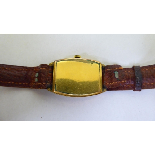 245 - A Nivada rolled gold cased, manual wind wristwatch, faced by an Arabic dial, on a brown leather stra... 