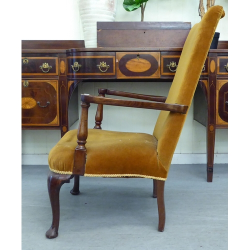 253 - A 1930s mahogany framed open armchair, upholstered in a gold fabric, raised on cabriole legs