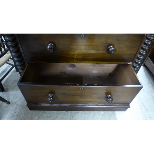 256 - A late Victorian mahogany dressing room chest, comprising four long drawers between spiraltwist, fla... 