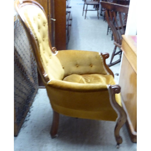 257 - A late Victorian mahogany framed grandfather chair with a high spoonback, upholstered in old gold fa... 