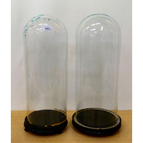 283 - Two glass clock domes, on plinths  19