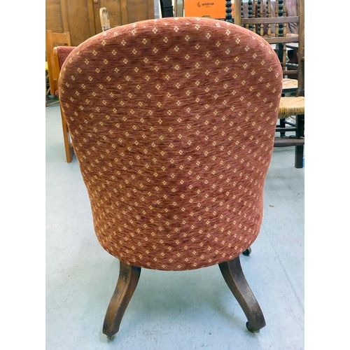 294 - A late 19thC rosewood framed and later red fabric upholstered nursing chair, raised on turned forele... 