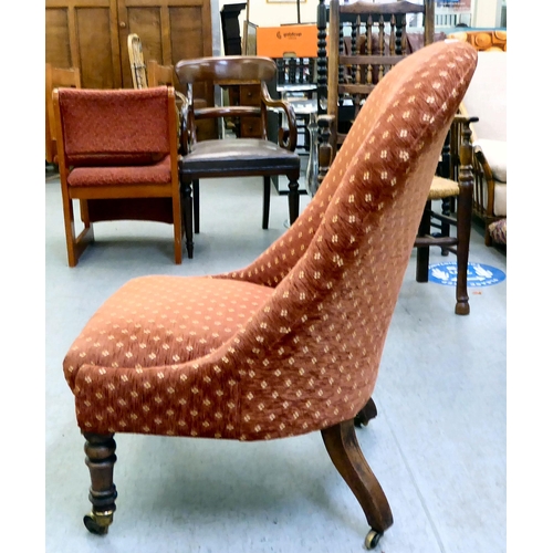 294 - A late 19thC rosewood framed and later red fabric upholstered nursing chair, raised on turned forele... 